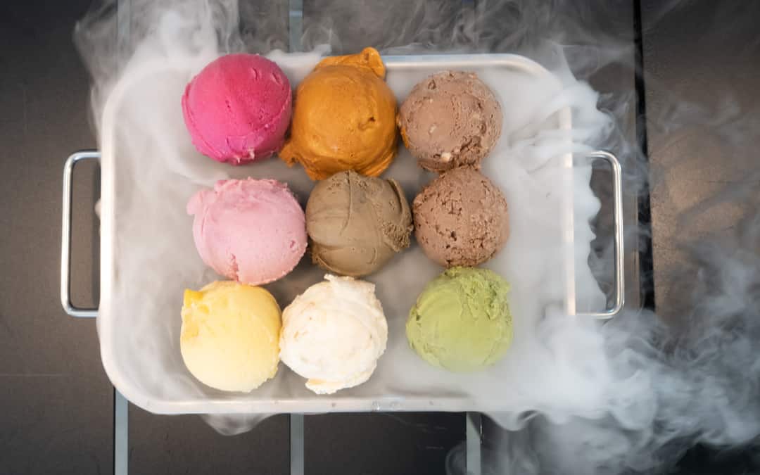 colorful ice-cream with dry ice in the black table