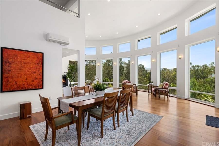 Open Dining Room With Soaring Ceilings And Wall Of Windows