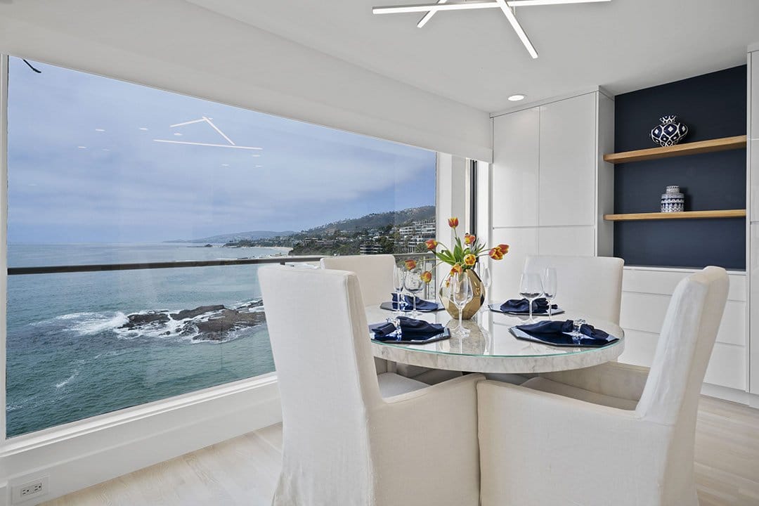 Condo Interior, Dining Room Table With Wall Of Glass Overlooking Ocean View