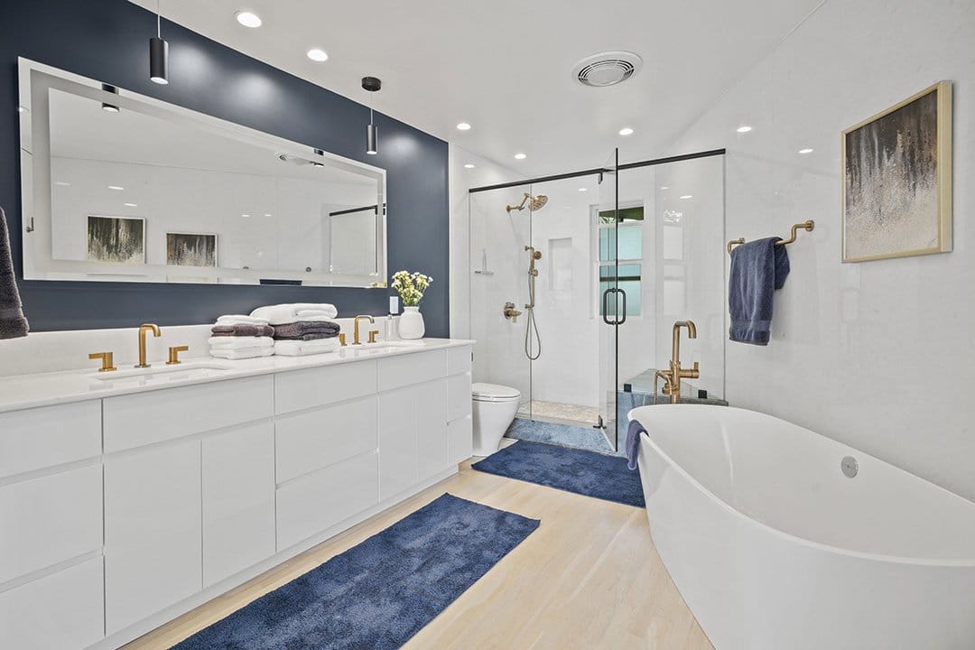 Luxury Bathroom With A Large Custom Shower, Soaking Tub, Quartzite Walls, Dual Vanity, And New High-End Fixtures.