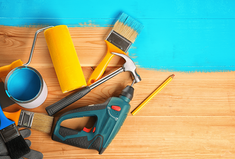tools on wooden background with blue paint