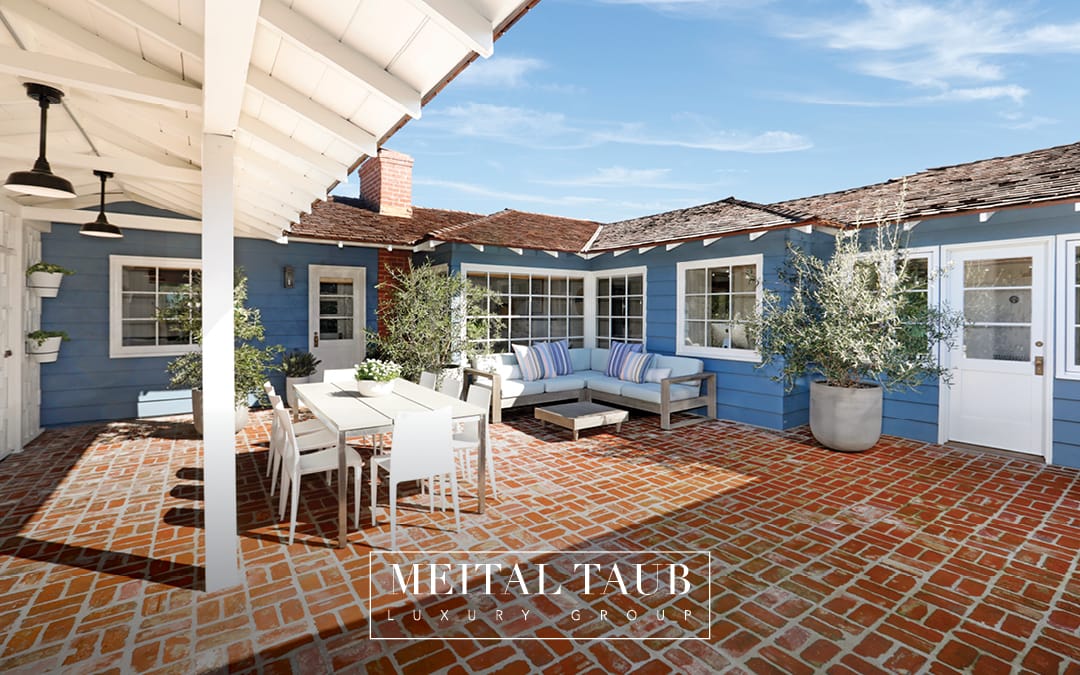 Interior Courtyard Of Charming Blue Home With Outdoor Dining And Entertaining Area
