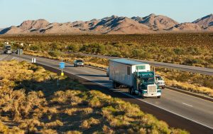 Moving truck driving through the desert landscape