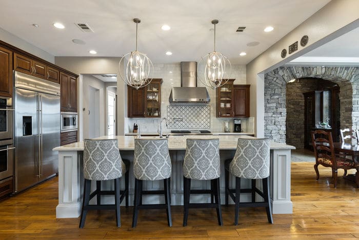 Grand kitchen with pendant lighting, large island, and seating.