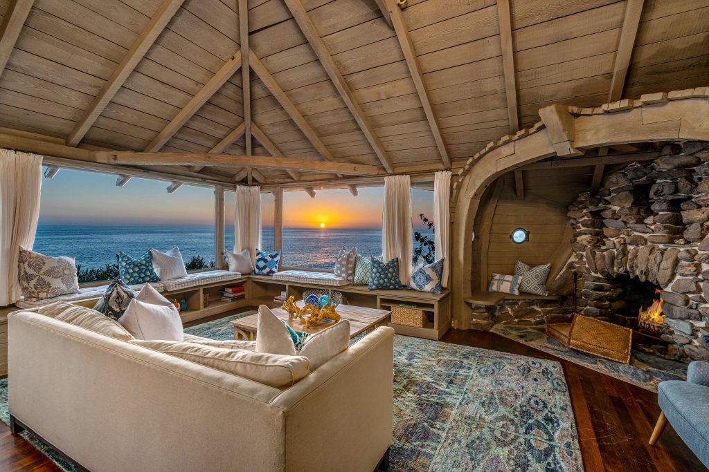 Interior Of The Ark In Laguna Beach, Ca With Fireplace And Ocean Views At Sunset